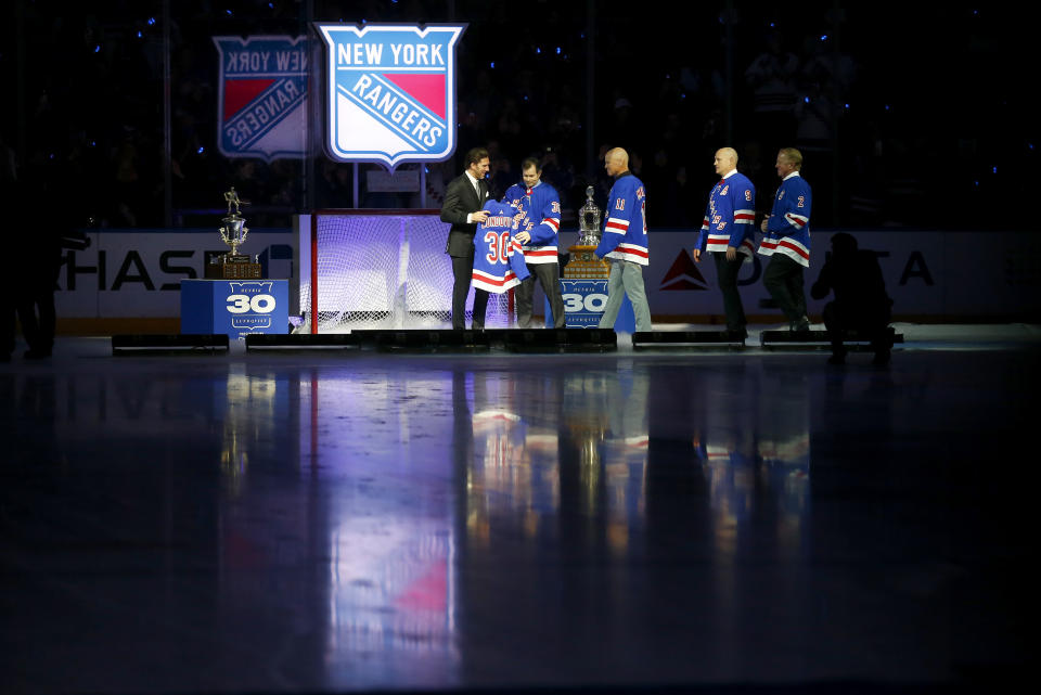 The New York Rangers retire number 30 of former goaltender Henrik Lundqvist, far left, before an NHL hockey game between the Rangers and the Minnesota Wild Friday, Jan. 28, 2022 in New York. He was joined on the ice by four former Rangers who have also had their number retired, left to right, Mike Richter, Mark Messier, Adam Graves and Brian Leetch.(AP Photo/John Munson)