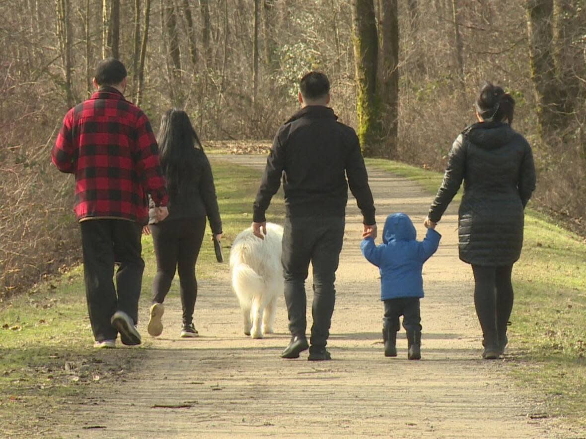 Josh Wong's family visiting the Fraser Foreshore Park in Burnaby, B.C. Part of the park will be paved over to create an organic waste composting facility, with some residents opposed to the plan. (Janella Hamilton/CBC - image credit)