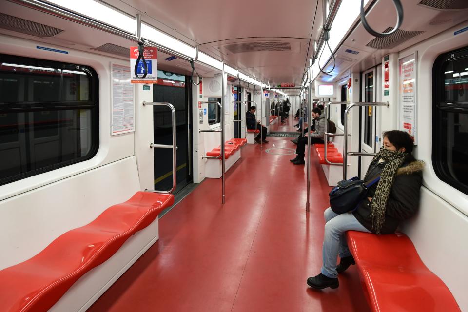 A few commuters travel in the underground metro in Milan on March 10, 2020 after Italy imposed unprecedented national restrictions on its 60 million people. (Credit: Miguel Medina/AFP)