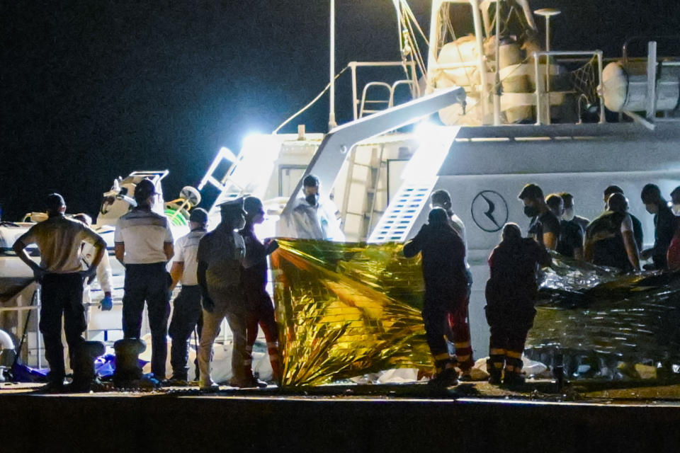 FILE - The bodies of some of the 64 migrants missing in the Mediterranean Sea after their ship wrecked off Italy's southern coast are disembarked at the Italian southern port-city of Roccella Ionica, early Wednesday, June 19, 2024. The Italian coast guard on Thursday recovered 12 bodies from a weekend shipwreck in the Ionian Sea off the southern Italian coast line, bringing to 20 the number of known victims. Dozens more were missing and presumed dead. (AP Photo/Valeria Ferraro, File)