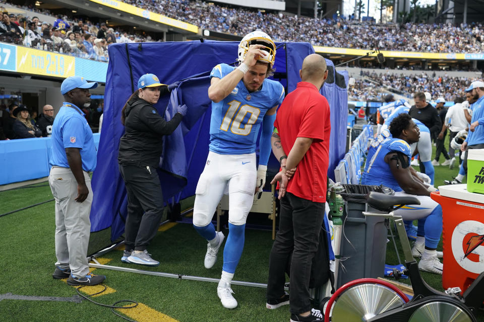 Los Angeles Chargers quarterback Justin Herbert comes out of a tent with a brace on this left hand during the second half of an NFL football game against the Las Vegas Raiders Sunday, Oct. 1, 2023, in Inglewood, Calif. (AP Photo/Ashley Landis)