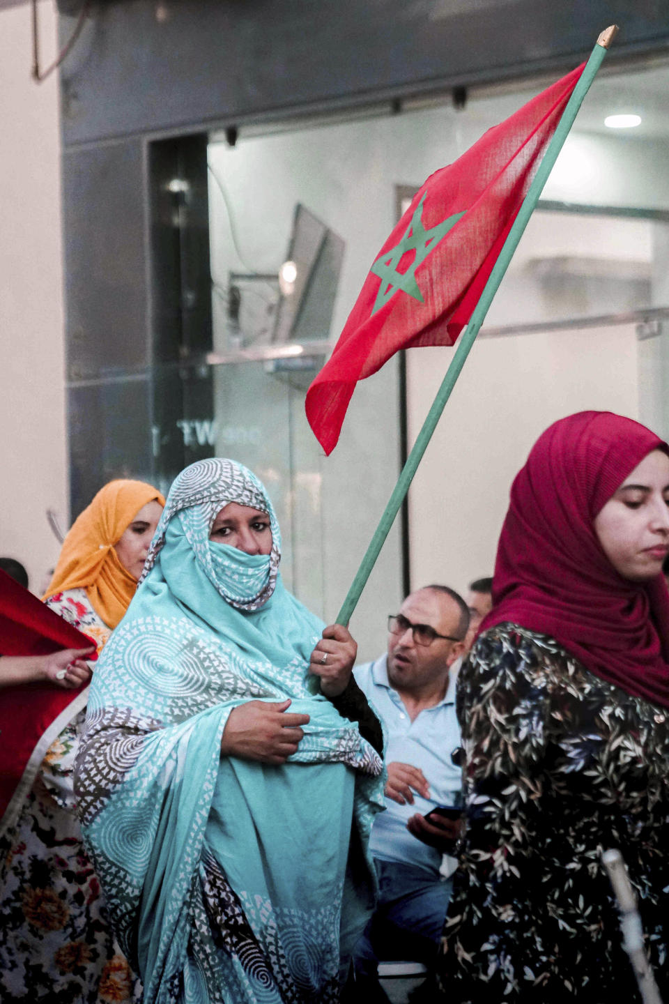 A woman wearing a Sahrawis traditional outfit celebrates Morocco's World Cup victory against Portugal in the Morocco-administered Western Sahara city of Laayoune, Saturday, Dec. 10, 2022. (AP Photo/Noureddine Abakchou)