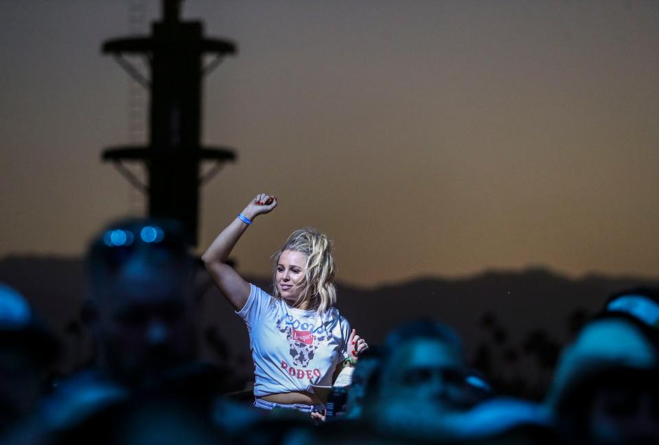 A festivalgoer atop someone else’s shoulders dances to The Black Crowes as they perform on the Mane Stage during the Stagecoach country music festival in Indio, Calif., Sunday, May 1, 2022.