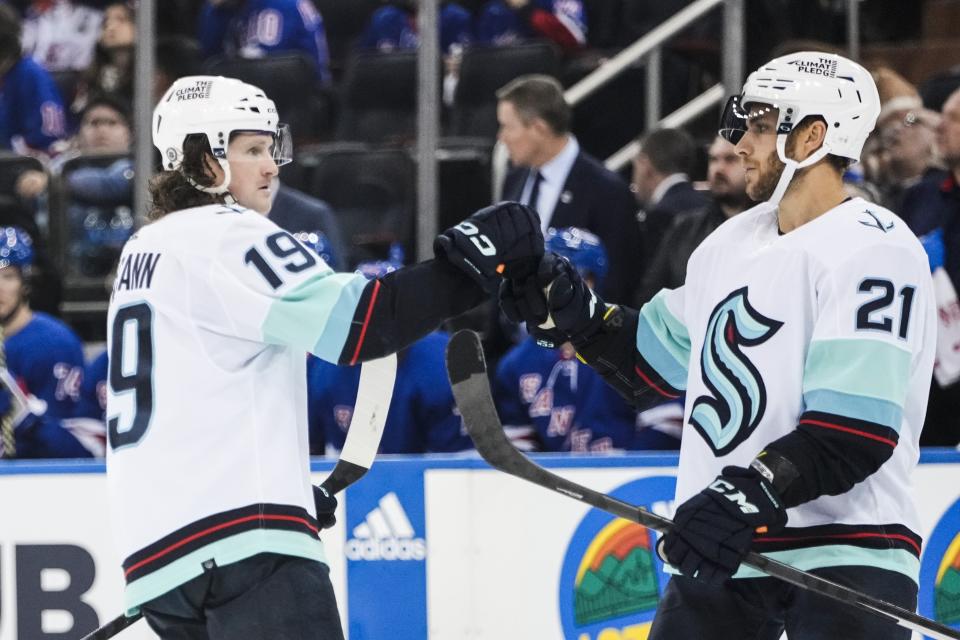 Seattle Kraken's Jared McCann (19) celebrates with teammate Alex Wennberg (21) after scoring during the third period of an NHL hockey game against the New York Rangers, Friday, Feb. 10, 2023, in New York. (AP Photo/Frank Franklin II)