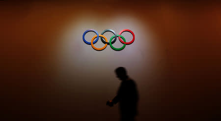 A man walks past the Olympic Rings as he walks out of the 133rd International Olympic Committee (IOC) session in Buenos Aires, Argentina October 8, 2018. REUTERS/Marcos Brindicci