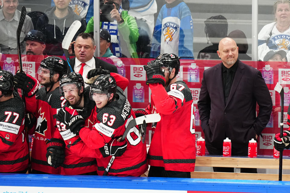 Canada's head coach Andre Tourigny smiles as his bench celebrates its victory over Germany during the gold medal match at the Ice Hockey World Championship in Tampere, Finland, Sunday, May 28, 2023. Canada won 5-2. (AP Photo/Pavel Golovkin)