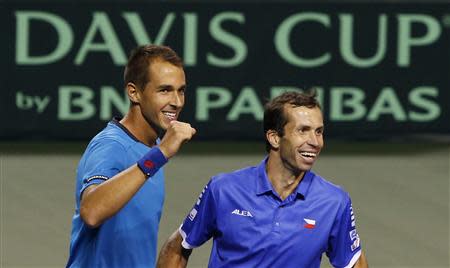 Lukas Rosol (L) and Radek Stepanek of the Czech Republic celebrate after winning their Davis Cup quarter-final men's doubles tennis match against Japan's Tatsuma Ito and Yasutaka Uchiyama in Tokyo April 5, 2014. This win ensures the Czech team proceeds to the Davis Cup semi-finals. REUTERS/Yuya Shino