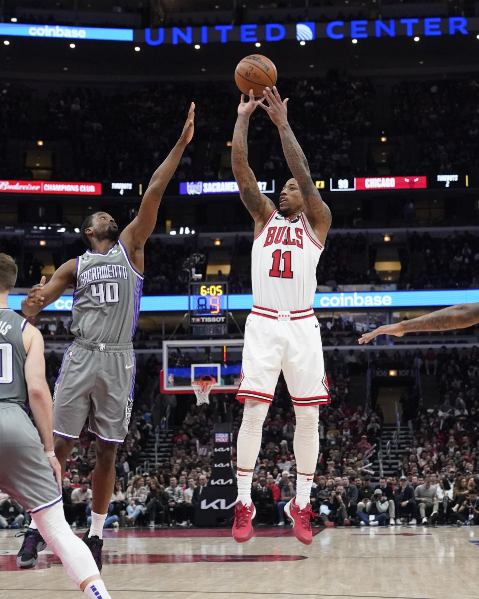 Chicago Bulls' DeMar DeRozan shoots over Sacramento Kings' Harrison Barnes during the second half of an NBA basketball game Wednesday, March 15, 2023, in Chicago. (AP Photo/Charles Rex Arbogast)