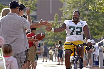 Bike ride to and from training-camp practices is one of the many things that uniquely connects Packers players to their fans