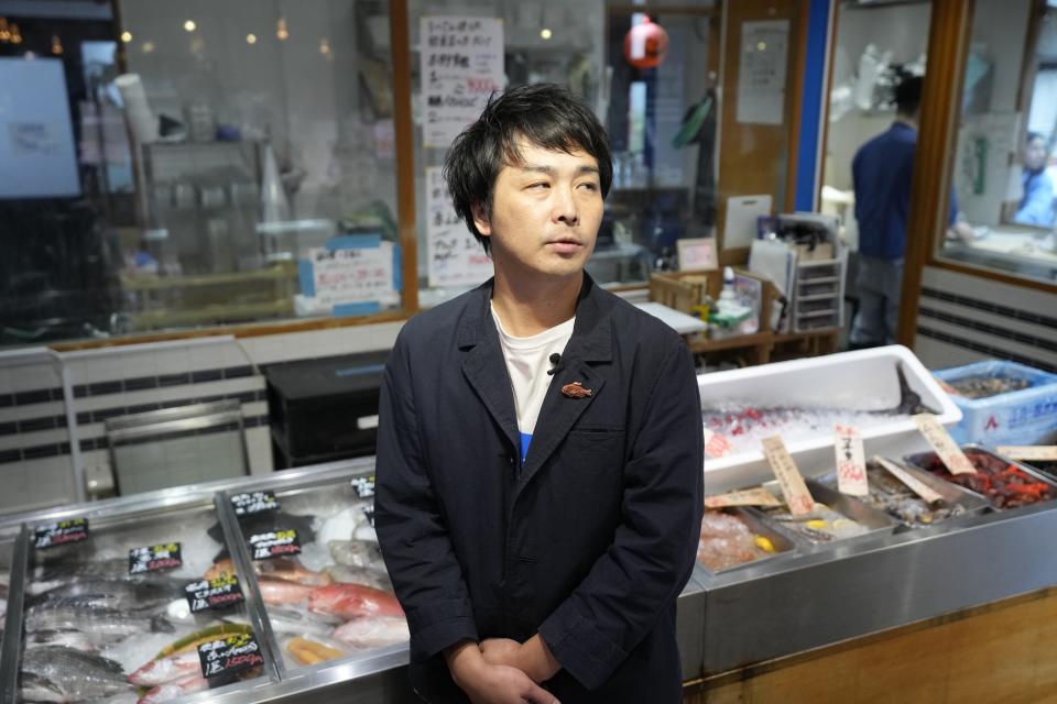 Futoshi Kinoshita, executive of Foodison Inc. speaks with The Associated Press at Sakana Bacca, a seafood retailer, Tuesday, Oct. 31, 2023, in Tokyo. “Before the discharge began, we were worried that consumers may stay away from Fukushima fish, but we saw a significant increase of our customers asking for Fukushima fish,” said Kinoshita. (AP Photo/Eugene Hoshiko)