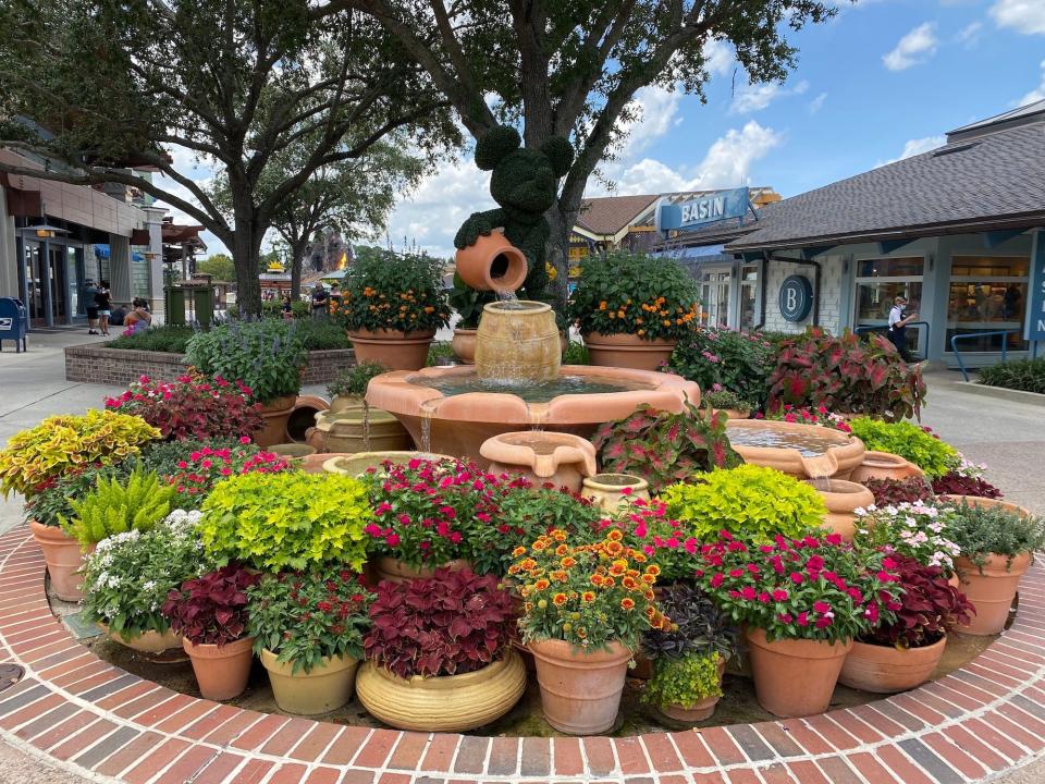 A Mickey Mouse topiary and planters at Disney Springs in August 2021.