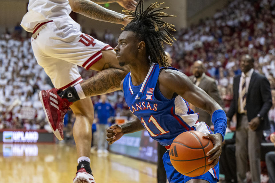 Kansas guard Jamari McDowell (11) makes a move along the baseline during the first half of an NCAA college basketball game against Indiana, Saturday, Dec. 16, 2023, in Bloomington, Ind. (AP Photo/Doug McSchooler)