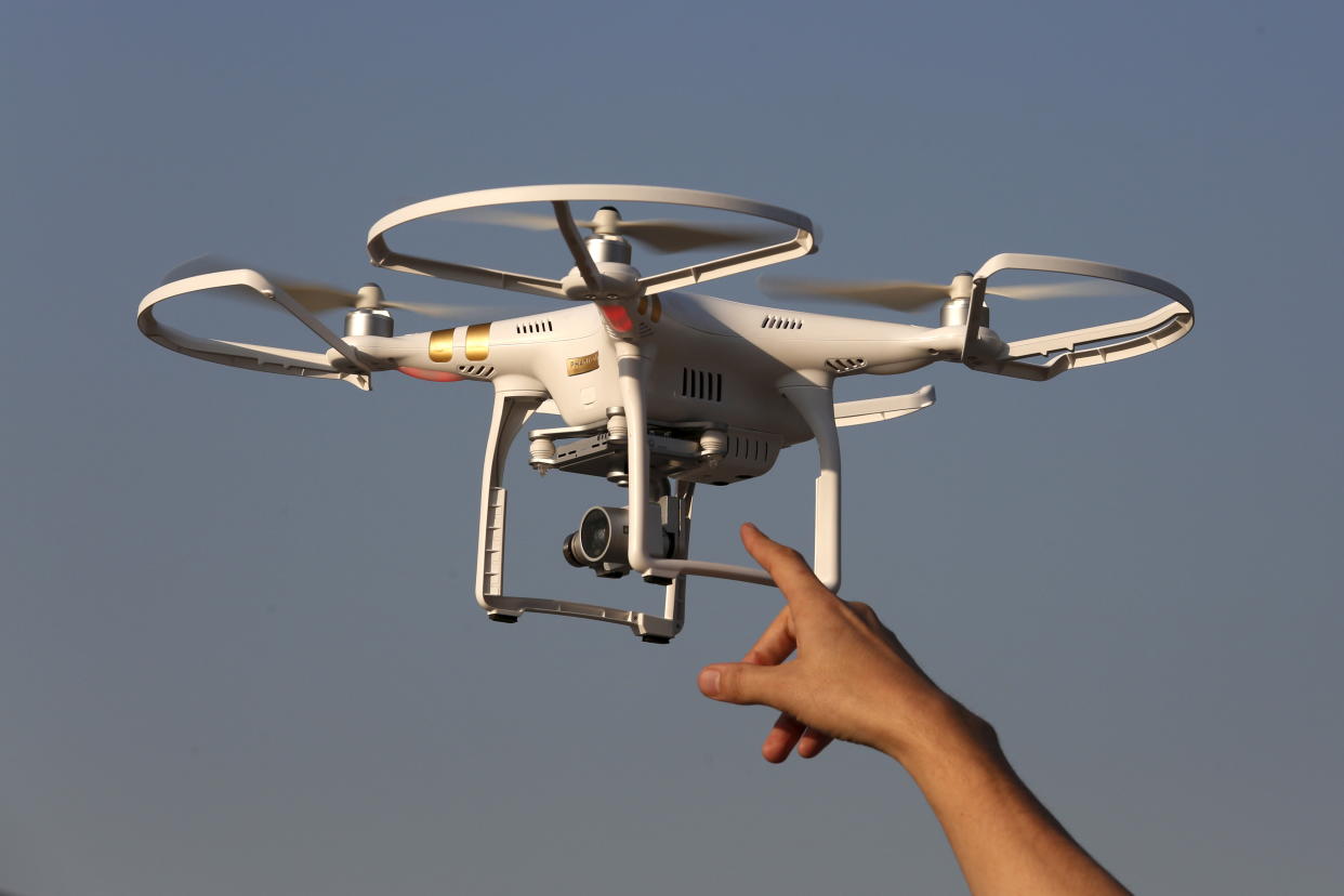 Michael Perry, Director of Strategic Partnerships of DJI, reaches a drone during a demonstration in Shenzhen, China December 18, 2015, two days before the opening of DJI's first flagship store. Chinese drone developers are racking up an impressive list of aerial solutions for a growing variety of demands, from police surveillance to agricultural mapping and traffic management. Already well established as a world leader in drone manufacturing, China is slowly emerging as a world-class innovator, not just a duplicator of foreign designs.   REUTERS/Bobby Yip