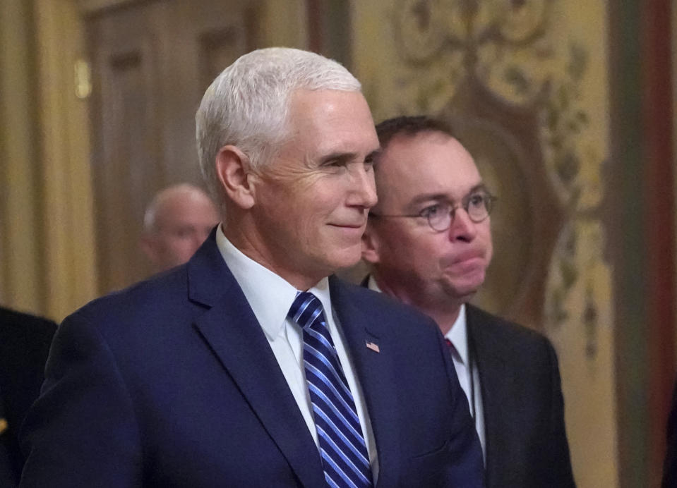 Vice President Mike Pence, left, walks with acting-White House Chief of Staff Mick Mulvaney, as they arrive at the Capitol as Congress resumes talks on funding without a compromise over money for President Donald Trump's promised wall along the U.S.-Mexico border, in Washington, Saturday, Dec. 22, 2018. (AP Photo/J. Scott Applewhite)