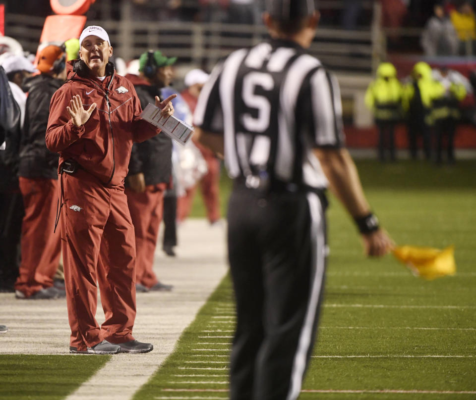 Arkansas coach Chad Morris talks with an official after a penalty during the first half of the team’s NCAA college football game against Mississippi on Saturday, Oct. 13, 2018, in Little Rock, Ark. (AP Photo/Michael Woods)