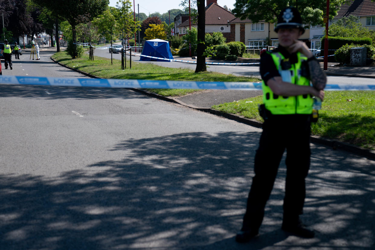 A police officer stands near the scene on College Road, Kingstanding, north of Birmingham, where a 14-year-old boy died after being stabbed on Monday evening. Police have launched a murder investigation and are hunting up to seven people in connection with the attack. Picture date: Tuesday June 1, 2021.