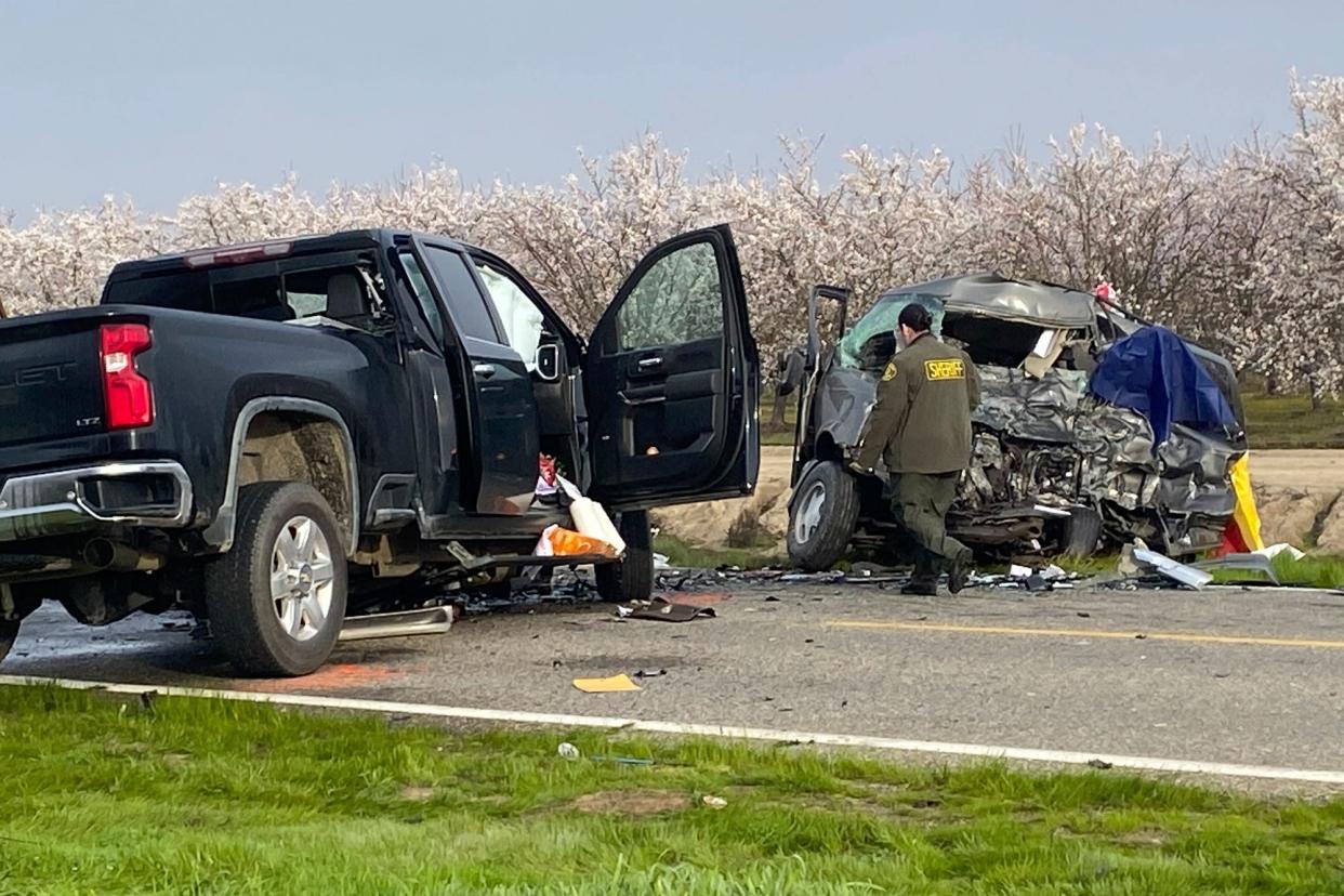 The site of a head-on crash involving a van and a pickup truck where eight people were killed is checked in Madera County, Calif., Friday, Feb. 23, 2024. California Highway Patrol Officer Javier Ruvalcaba told the Fresno Bee that seven of those killed were farmworkers traveling in a van. The other person killed was in a pickup truck, he said.