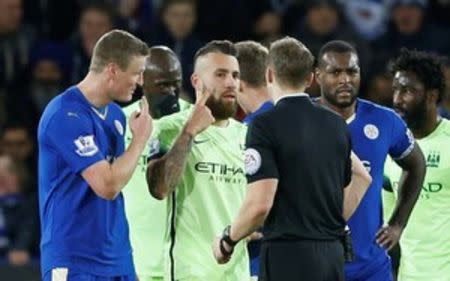 Football Soccer - Leicester City v Manchester City - Barclays Premier League - King Power Stadium - 29/12/15 Manchester City's Nicolas Otamendi and Leicester City's Robert Huth with Referee Craig Pawson Action Images via Reuters / Carl Recine Livepic