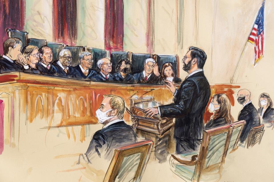 This artist sketch depicts Marc Hearron, petitioner for Whole Woman's Health, standing while speaking to the Supreme Court, Monday, Nov. 1, 2021, in Washington. Seated to Hearron's left is Judd Stone II, Texas Solicitor General. Justices seated from left are Associate Justice Brett Kavanaugh, Associate Justice Elena Kagan, Associate Justice Samuel Alito, Associate Justice Clarence Thomas, Chief Justice John Roberts, Associate Justice Stephen Breyer, Associate Justice Sonia Sotomayor, Associated Justice Neil Gorsuch and Associate Justice Amy Coney Barrett. (Dana Verkouteren via AP)