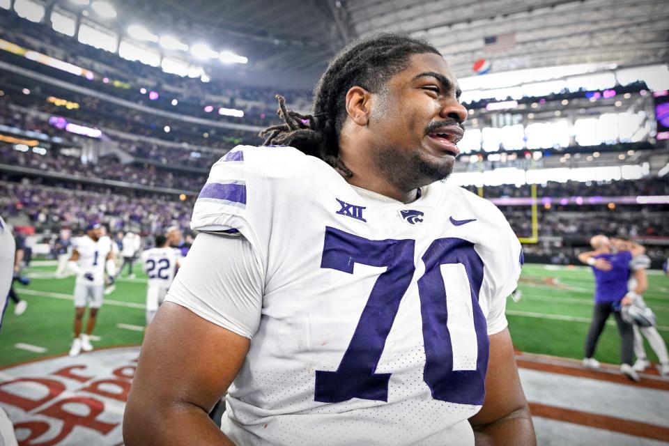 Dec 3, 2022; Arlington, TX, USA; Kansas State Wildcats offensive lineman KT Leveston (70) celebrates at midfield after the Wildcats win the Big 12 championship after defeating the TCU Horned Frogs overtime at AT&T Stadium. Mandatory Credit: Jerome Miron-USA TODAY Sports