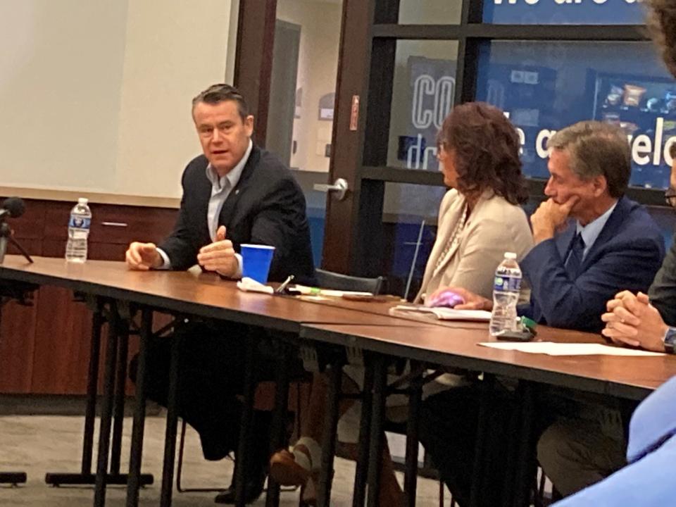 U.S. Sen. Todd Young (left) discusses Housing issues in Indiana at the ECI Regional Planning District meeting Tuesday. ECI staff member Michelle Badders (center) and Muncie Mayor Dan Ridenour listen.
