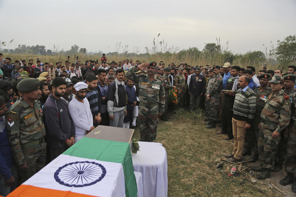 Indian Army soldiers with family members and villagers pay their last respect during the cremation ceremony of soldier Varun Katal in village Mawa in Samba district, 62 kilometers (51 miles) from Jammu, India, Sunday, Nov. 11, 2018. Katal was killed when Pakistani soldiers fired at Indian positions along the highly militarized frontier in disputed Kashmir on Saturday, Indian military said. (AP Photo/Channi Anand)