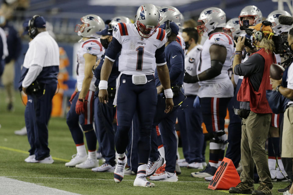 New England Patriots quarterback Cam Newton (1) reacts on the sideline during the fourth quarter of an NFL football game against the Seattle Seahawks, Sunday, Sept. 20, 2020, in Seattle. The Seahawks won 35-30. (AP Photo/John Froschauer)