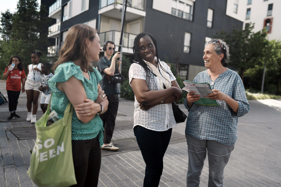 Hard-left candidate, Rachel Keke, center, speaks with members of her campaign crew as she distributes leaflet to residents of Fresnes, south of Paris, ahead of the legislative elections, Thursday, June 16, 2022. The former chambermaid, Rachel Keke, took the stand during political rallies across France, to speak about her grueling but successful battle against French hotel giant Accor to obtain better work pay and conditions. (AP Photo/Thibault Camus)