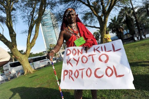 A Masi member of the Trans African Climate Caravan of Hope displays a placard during the UN Cilmate Change conference in Durban on November 28, 2011