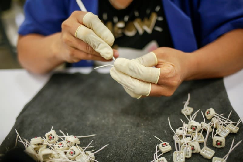 An employee works at Ark de Mexico, an assembly factory that makes wire harnesses and electric components for the automobile industry, in Ciudad Juarez