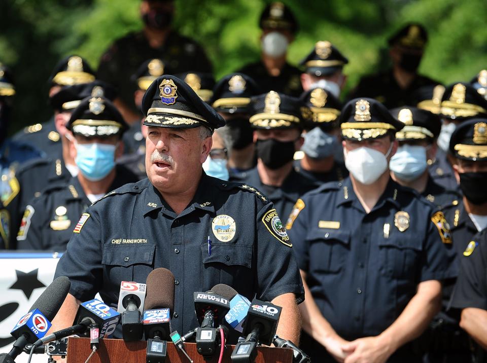 Jeff Farnsworth, then-Hampden police chief and then-president of the Massachusetts Chiefs of Police Association, speaks about proposed police reform bills surrounded by dozens of police chiefs at an October 2020 rally. In 2021, Farnsworth was hired as a senior policy advisor at the Executive Office of Public Safety and Security.