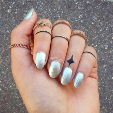 People are getting tiny tattoos on their cuticles, and they look so pretty