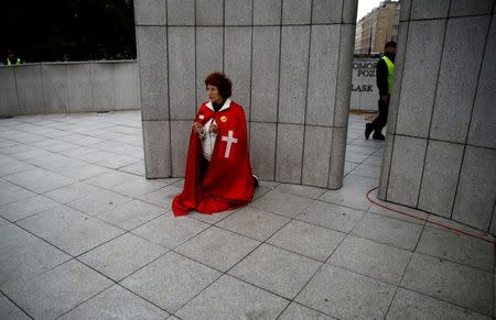 A woman kneels and prays as she takes part in an anti-abortion demonstration in front of the Parliament in Warsaw, Poland September 22, 2016. REUTERS/Kacper Pempel