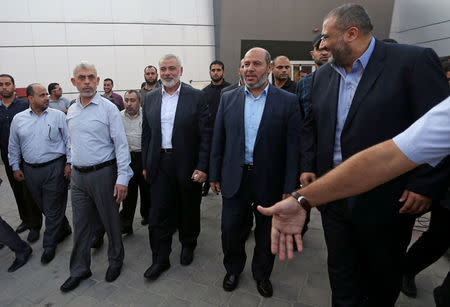 Hamas Gaza Chief Yahya Al-Sinwar, Hamas Chief Ismail Haniyeh and senior Hamas leader Khalil al-Hayya arrive at the Rafah border crossing in the southern Gaza Strip September 19, 2017. REUTERS/Ibraheem Abu Mustafa