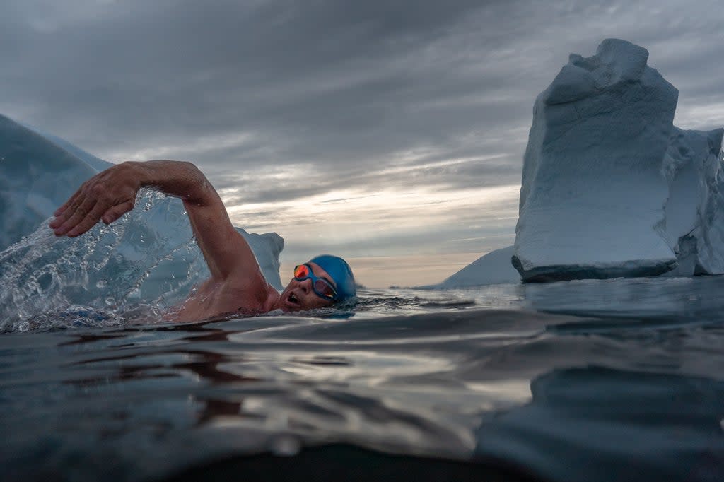 Lewis Pugh swimming among icebergs to to highlight the impacts of the climate crisis  (Olle Nordell/Lewis Pugh Foundation/PA)
