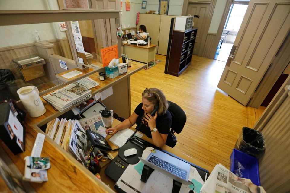 Delia Moreira, foreground, and Jennifer Lopes, background, at the Immigrants Assistance Center on the second floor of Casa da Saudade on Crapo Street in New Bedford.