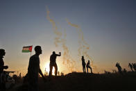 <p>Palestinians protest as tear gas fumes erupt near the border with Israel east of Khan Yunis in the southern Gaza Strip on May 15, 2018 marking 70th anniversary of Nakba â also known as Day of the Catastrophe in 1948 â and against the U.S. relocation of its embassy from Tel Aviv to Jerusalem. (Photo: Said Khatib/AFP/Getty Images) </p>