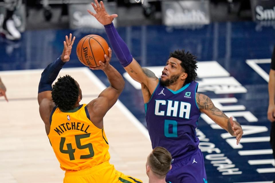 Utah Jazz guard Donovan Mitchell (45) shoots as Charlotte Hornets forward Miles Bridges (0) defends in the second half during an NBA basketball game Monday, Feb. 22, 2021, in Salt Lake City.