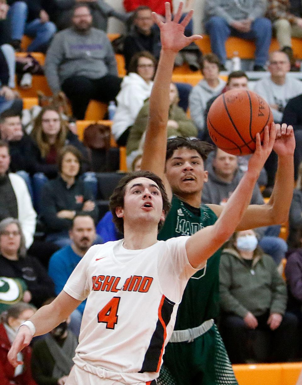 Ashland High School's Luke Denbow (4) shoots as Madison High School's Isaac Brooks (3) defends during high school boys basketball action on Friday, Jan. 21, 2022 at Arrow Arena. TOM E. PUSKAR/TIMES-GAZETTE.COM