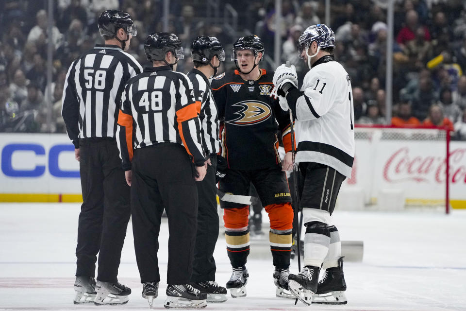 Anaheim Ducks right wing Jakob Silfverberg, second from right, and Los Angeles Kings center Anze Kopitar, right, speak with officials during the second period of an NHL hockey game Saturday, Feb. 24, 2024, in Los Angeles. (AP Photo/Ryan Sun)