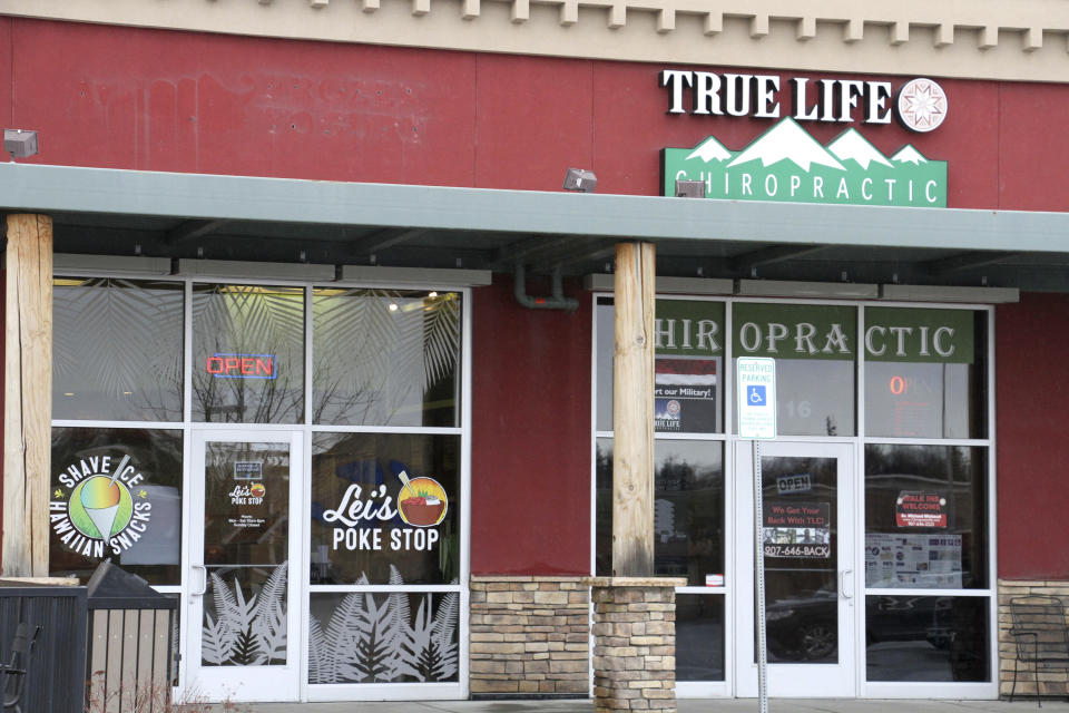 The exterior of Lei's Poke Stop, at left, is seen Wednesday, April 17, 2019, in Anchorage, Alaska. Hawaii lawmakers are considering adopting a resolution calling for the creation of legal protections for Native Hawaiian cultural intellectual property. The move comes after a Chicago restaurant chain owner shocked the island state by trademarking the name "Aloha Poke" and sending letters to similarly named cubed fish shops around the country demanding that they change their names, including this Anchorage store, which changed its name. (AP Photo/Mark Thiessen)