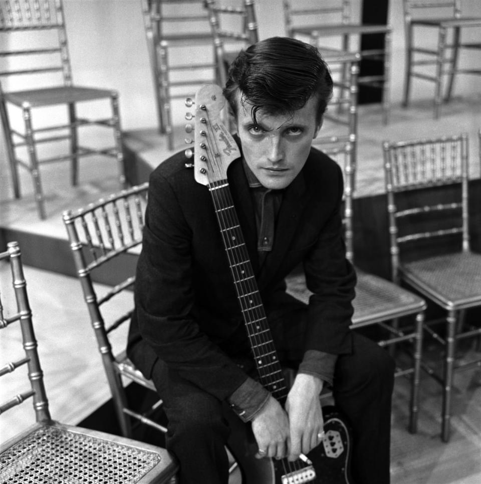 Jet Harris, posed, with Fender Bass VI guitar, 1963.