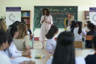 Former U.S. first lady Michelle Obama, center, speaks to female students at Can Giuoc high school in Long An province, Vietnam Monday, Dec. 9, 2019. Obama is on a visit to Vietnam to promote education for adolescent girls. (AP Photo/Hau Dinh)