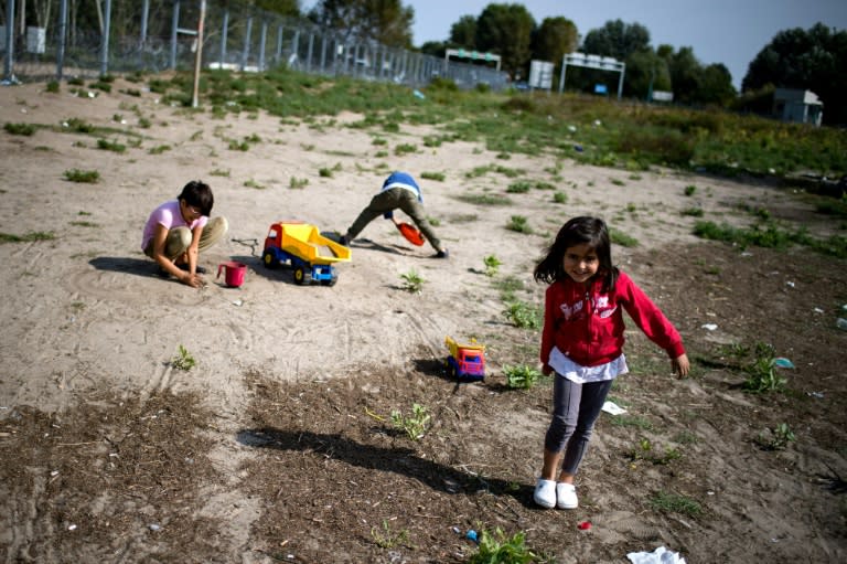 Children play at a makeshift refugee and migrants camp close to the border between Serbia and Hungary, near the Serbian town of Horgos