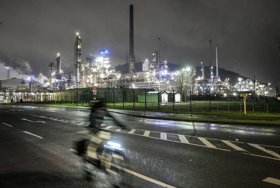 FILE - A worker leaves a BP refinery in Gelsenkirchen, Germany, Tuesday evening, April 5, 2022. Simon Stiell, U.N. climate chief, acknowledges nations didn’t do anything additional to address climate change itself at the COP27 U.N. Climate Summit, reducing emissions of heat-trapping gases. The progress made last year at the meeting in Glasgow was maintained, he said. “There was no backtracking." (AP Photo/Martin Meissner, File)