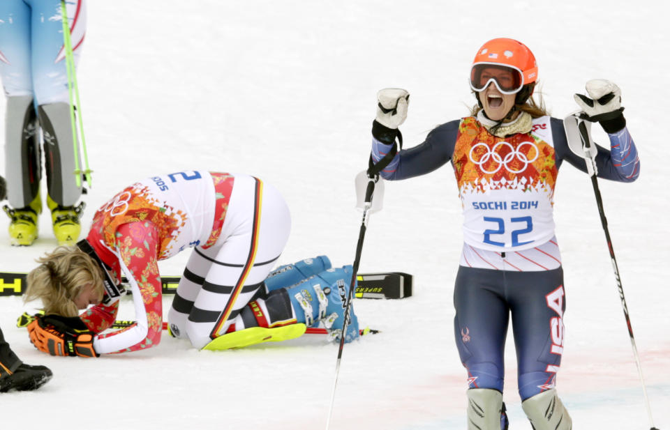 Germany's Maria Hoefl-Riesch, left, and United States' Julia Mancuso react after winning the gold and bronze medal in the women's supercombined at the Sochi 2014 Winter Olympics, Monday, Feb. 10, 2014, in Krasnaya Polyana, Russia. (AP Photo/Charles Krupa)