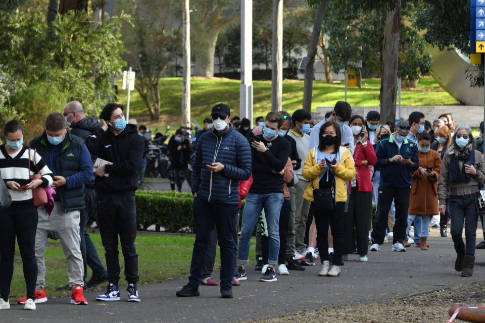 People are seen queued to receive their vaccination at the NSW Vaccine Centre at Homebush Olympic Park in Sydney, Monday, July 12, 2020. NSW recorded 112 new locally acquired cases of COVID-19 in the 24 hours to 8pm last night. (AAP Image/Mick Tsikas) NO ARCHIVING