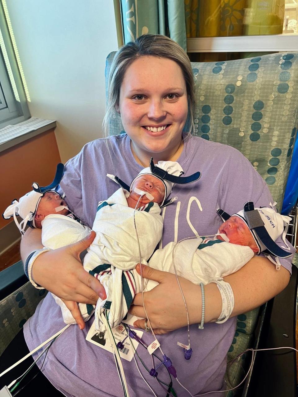 Hannah Mosteller holds her triplets for the first time.