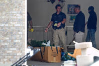 Authorities investigate a crime scene at a house in Pleasant Grove, Utah, Sunday, April 13, 2014. (AP Photo/Daily Herald, Mark Johnston)