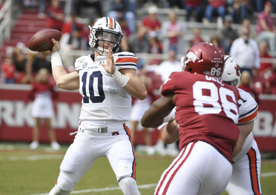 Auburn quarterback Bo Nix throws a pass against Arkansas during the first half of an NCAA college football game, Saturday, Oct. 19, 2019 in Fayetteville, Ark. (AP Photo/Michael Woods)
